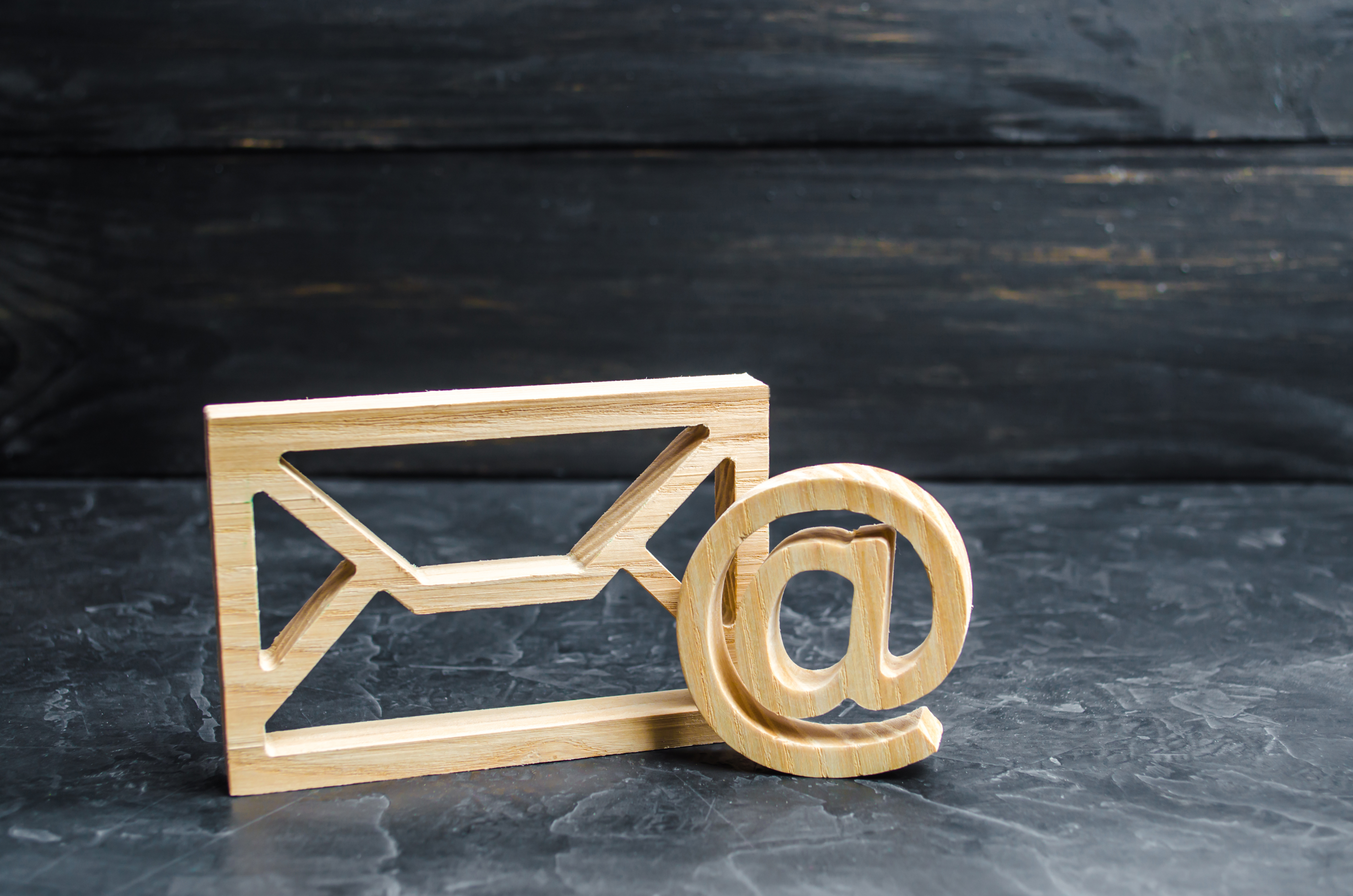 Envelope and email symbol on a dark concrete background. Concept email address. Internet technologies and contacts for communication. Communication over the network, business and correspondence.